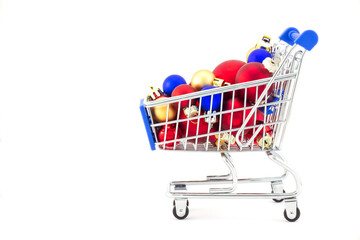 Christmas background with blue toy shopping trolley filled with red, blue and golden New year...