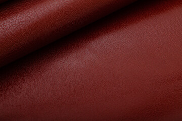 Brown dyed premium folded natural cow leather on the wooden table	