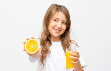 Woman drinking orange juice smiling showing oranges. Young beautiful mixed-race Caucasian model.
