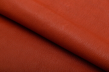 Premium brown colored folded natural leather on the wooden table