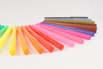 A set of colored markers on a light background close-up.