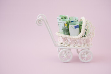 In the baby stroller there are euro bills. The concept of spending on a newborn. The concept of...