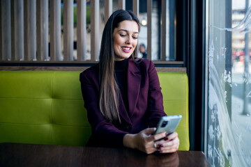 Young modern businesswoman using smartphone 