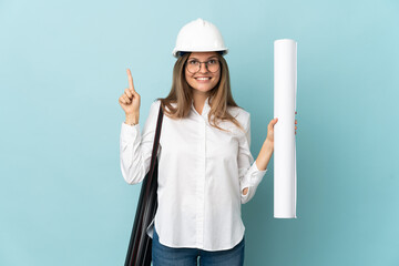 Slovak architect girl holding blueprints isolated on blue background pointing up a great idea