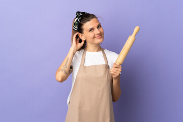 Cooker Slovak woman isolated on purple background having doubts