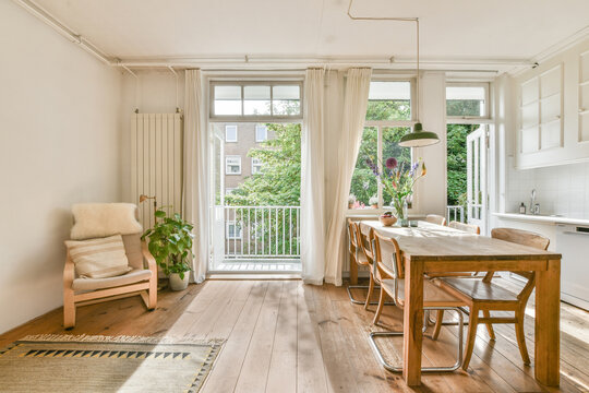 Dining room with wooden furniture near balcony