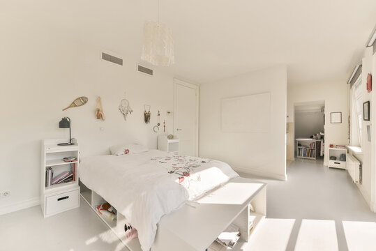 Teen bedroom interior with white furniture and walls with decorations