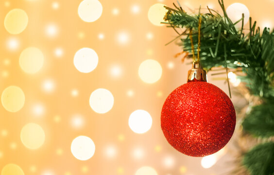 Christmas decoration, a red ball hanging on a spruce branch against a backdrop of a bokke with a copy of the space. High quality photo
