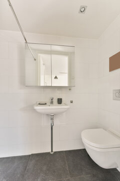 Modern bathroom interior with washstand against toilet bowl
