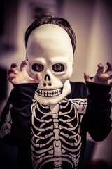 boy with a halloween costume with skull and skeleton