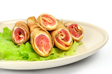 Salmon lavash rolls with cheese and herbs on glass plate, close up view