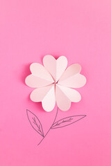 Creative flowers composition. Pink paper heart shape flower on the pink background. Copy space.