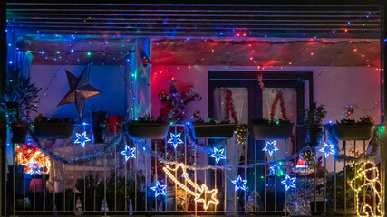 Balcony decorated with light garlands for Christmas	