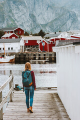 Traveler woman walking in Norway sightseeing Lofoten islands village Travel lifestyle outdoor...