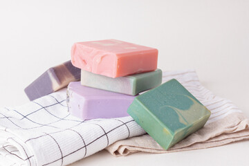 Set of natural handmade soap and towels on light background. Soap with different smells....