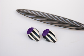 Naklejka premium Geometric striped flower studs of polymer clay. Handmade earrings.