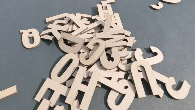 White DIY Word Wooden Letters Alphabet for Art Crafts Home Decor falling on table. Design decoration background Concept.