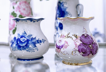 Two porcelain vases with floral patterns in the Gzhel style.