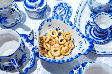 Bagels in a porcelain plate with blue ornament in the Russian Gzhel style.
