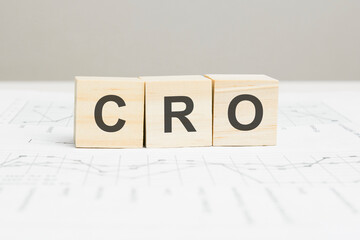 CRO wooden blocks word on grey background. CRO - conversion rate optimization, information concepts