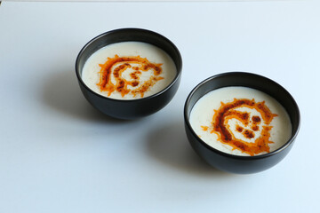 Yoghurt soup, traditional Turkish yoghurt soup with sauce. White background. Food concept and idea.