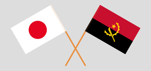 Crossed flags of Japan and Angola. Official colors. Correct proportion