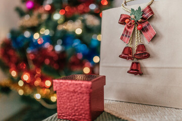 craft package with a gift on the background of a Christmas tree