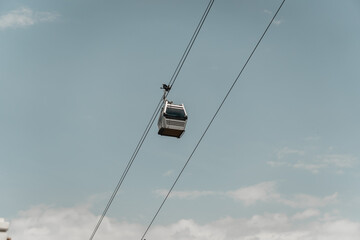 Cable car riding on the sky and heading to the station.