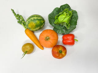A mix of mini vegetables and fruits on an isolated background