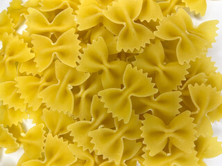 Raw Farfalle pasta on a white isolated background. Background from Farfalle