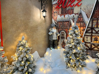 Santa Claus is standing at the Christmas tree under the lantern. Christmas Santa Claus. Christmas mood