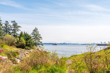 Ocean view with mountains, blue sky and white clouds in slow motion at summer day in Vancouver, Canada, North America. Day time on September 2021.