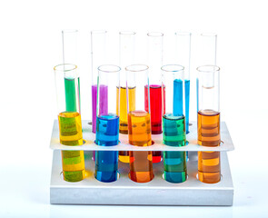 Glass laboratory materials such as erlenmeyer, tubes, and measuring cylinder containing colored...