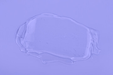 Clear liquid gel smear isolated on light purple background. Body and face care spa cosmetic concept. Transparent serum or hyaluronic acid texture. Trendy banner with 2022 color of the year very peri.