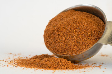 Ground Cinnamon Spilled from a Teaspoon