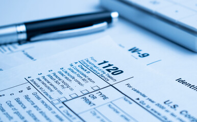The tax forms with money and the pen. Tax Day concept.