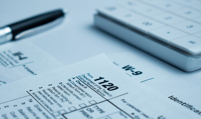 The tax forms with money and the pen. Tax Day concept.