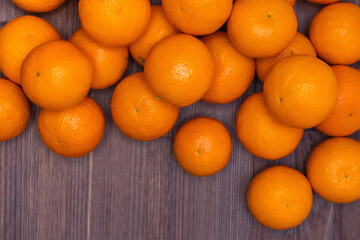 tangerines on a brown wooden board background