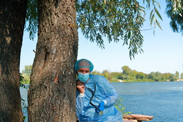 COVID-19 Pandemic Coronavirus. Caucasian male doctor pediatrician in medical facial mask hold...