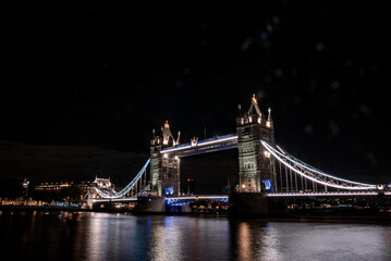 Iconic Tower Bridge view connecting London with Southwark over Thames River, UK. Beautiful view of the illuminated bridge at night.
