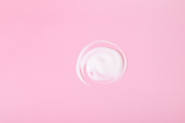 Smear of cosmetic or healing cream on pink surface