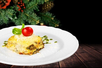 Piece of tasty hot lasagna on the desk. Traditional Italian food. Homemade pasta.