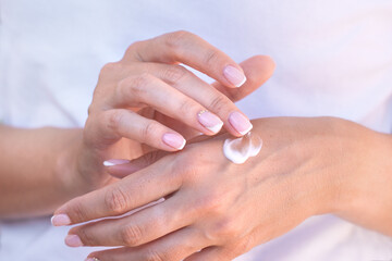 Close up of woman hands with moisturizer or hand cream. Hands skin care.