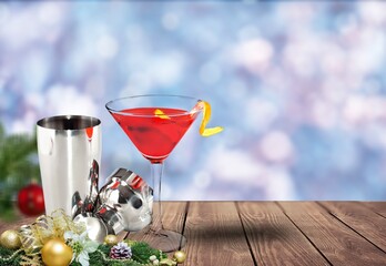 Winter alcoholic cocktail with berries, liquor for Christmas or New Year celebration. Holiday table setting