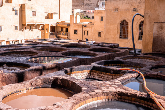 Brims of old stone water baths with colorful dyes used for traditional dyeing of leather
