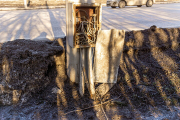 covered iron box with wires on the street lighting pole, unauthorized connection wire coming out of the box