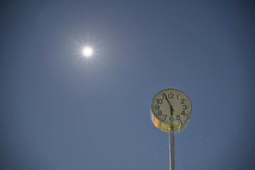 
Tokyo,Japan - December 22, 2021: A clock tower under the full moon

