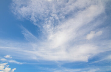 Naklejka na ściany i meble Slightly clouds on the blue sky showing white soft texture pattern.
