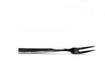 Closeup of meat fork isolated white background