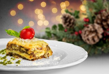Piece of tasty hot lasagna on the desk. Traditional Italian food. Homemade pasta.